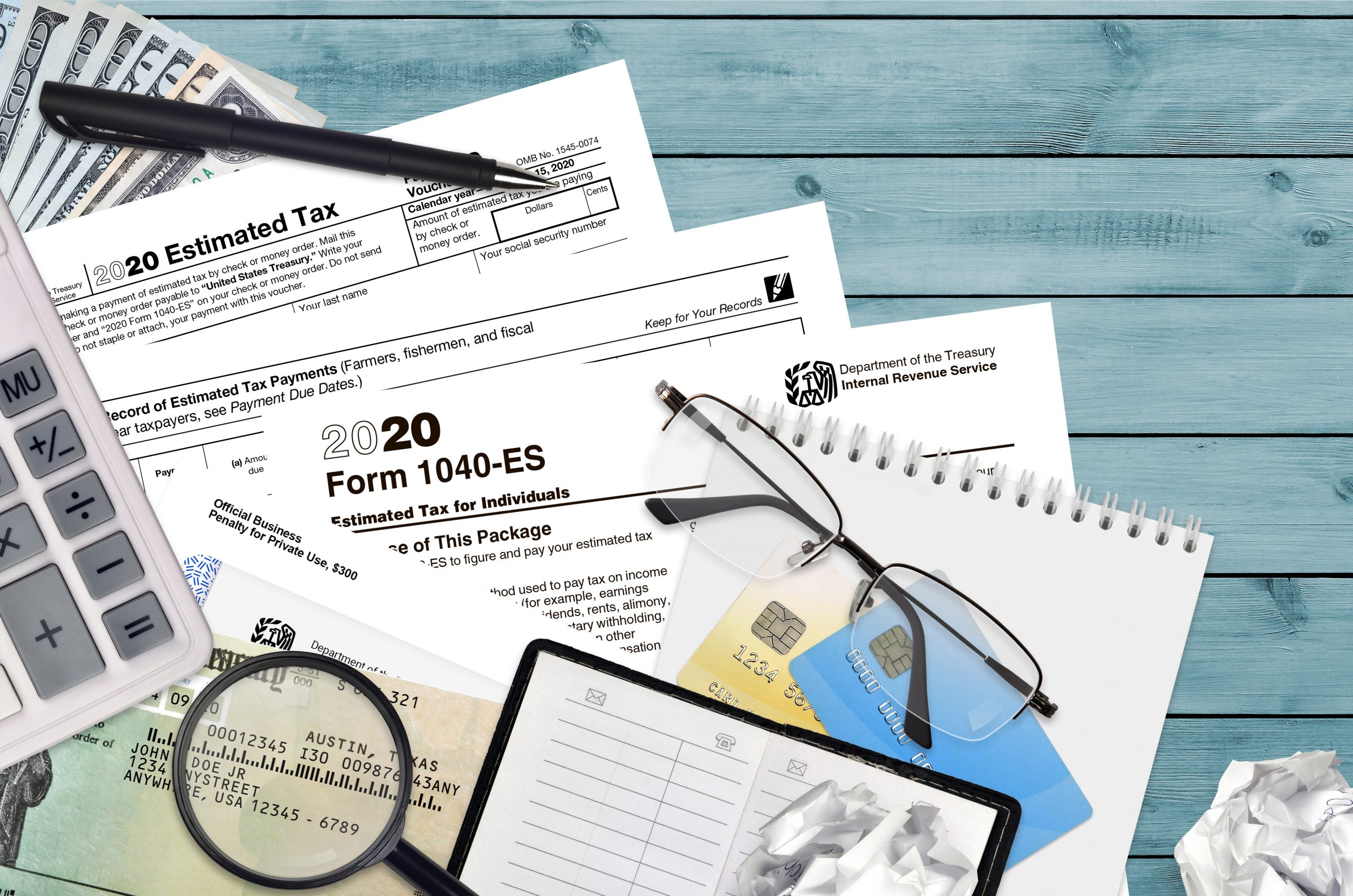 Tax paperwork with glasses and magnifying glass